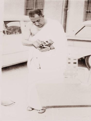 STANDING INFRONT OF HIS CAR DURING HAJJ